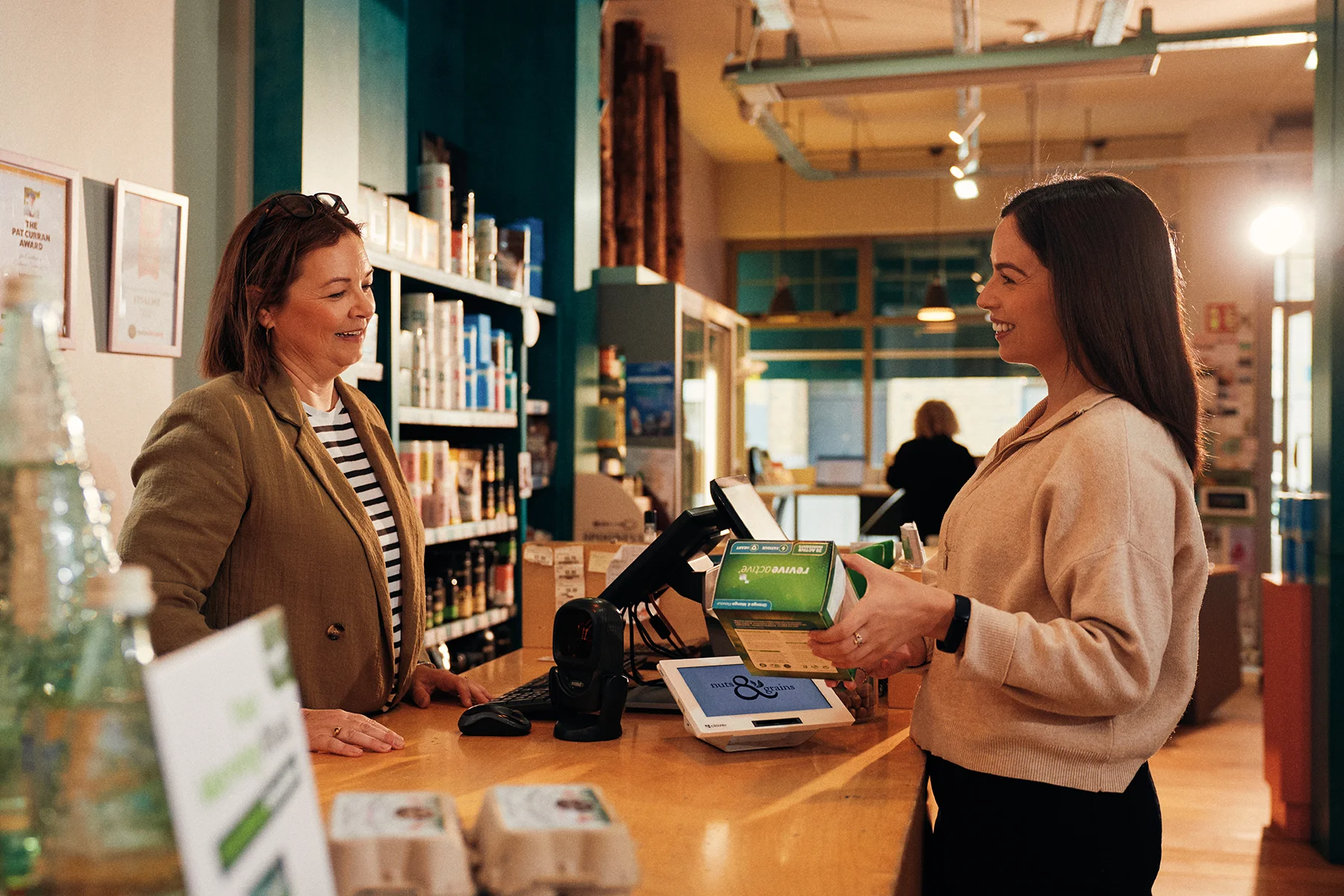 Revive active customer talking to staff at the till
