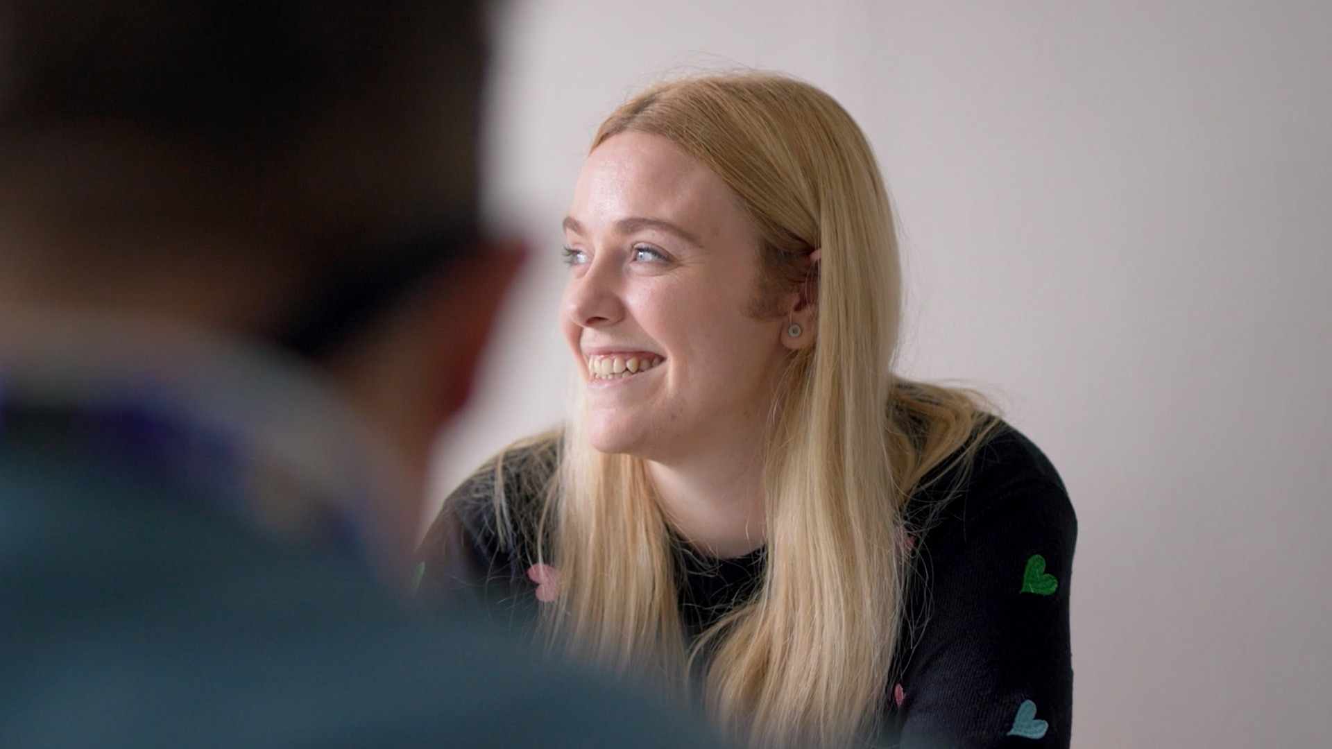 Woman smiling at desk in modern workspace