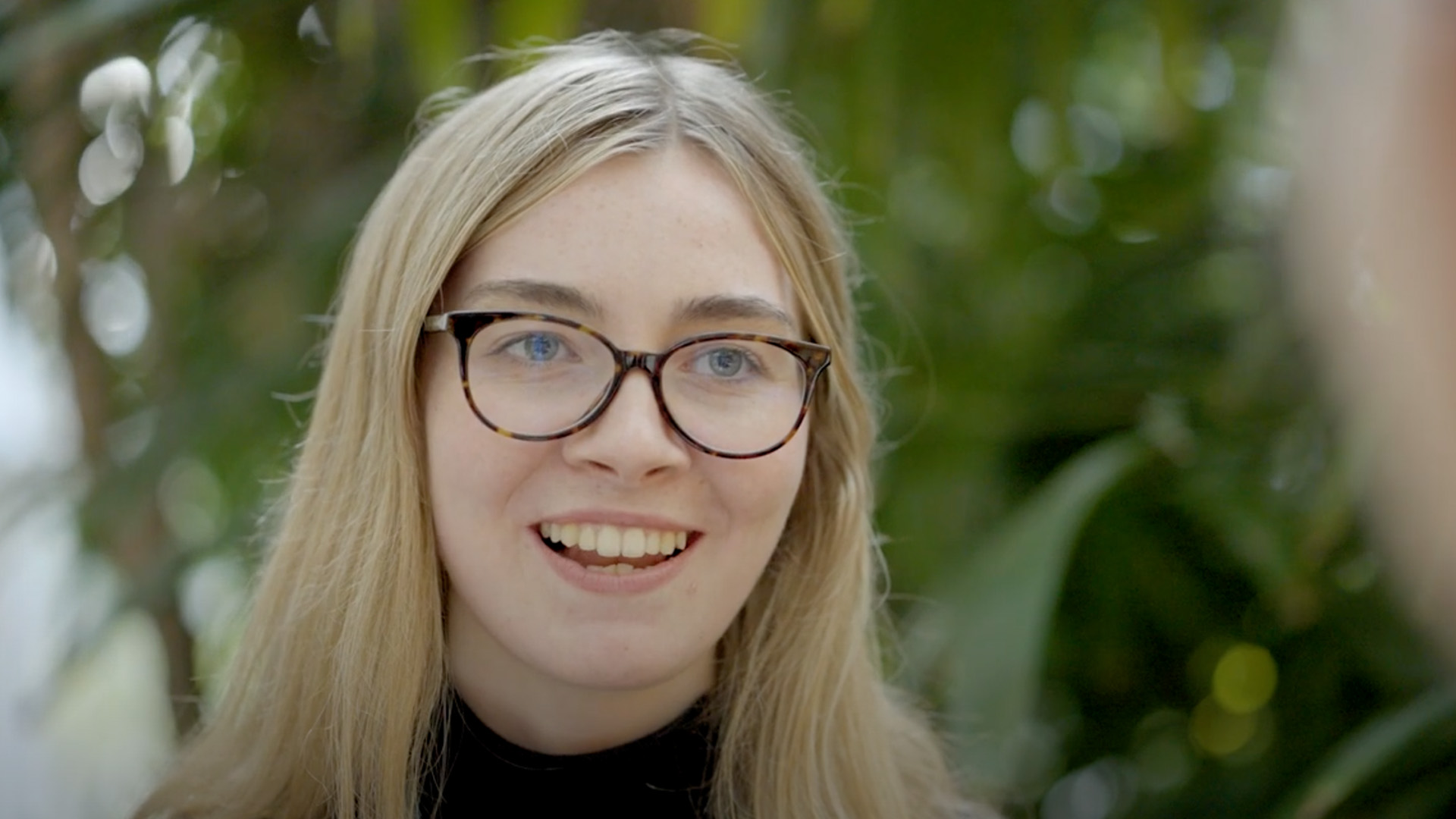 Woman smiling at desk in modern workplace