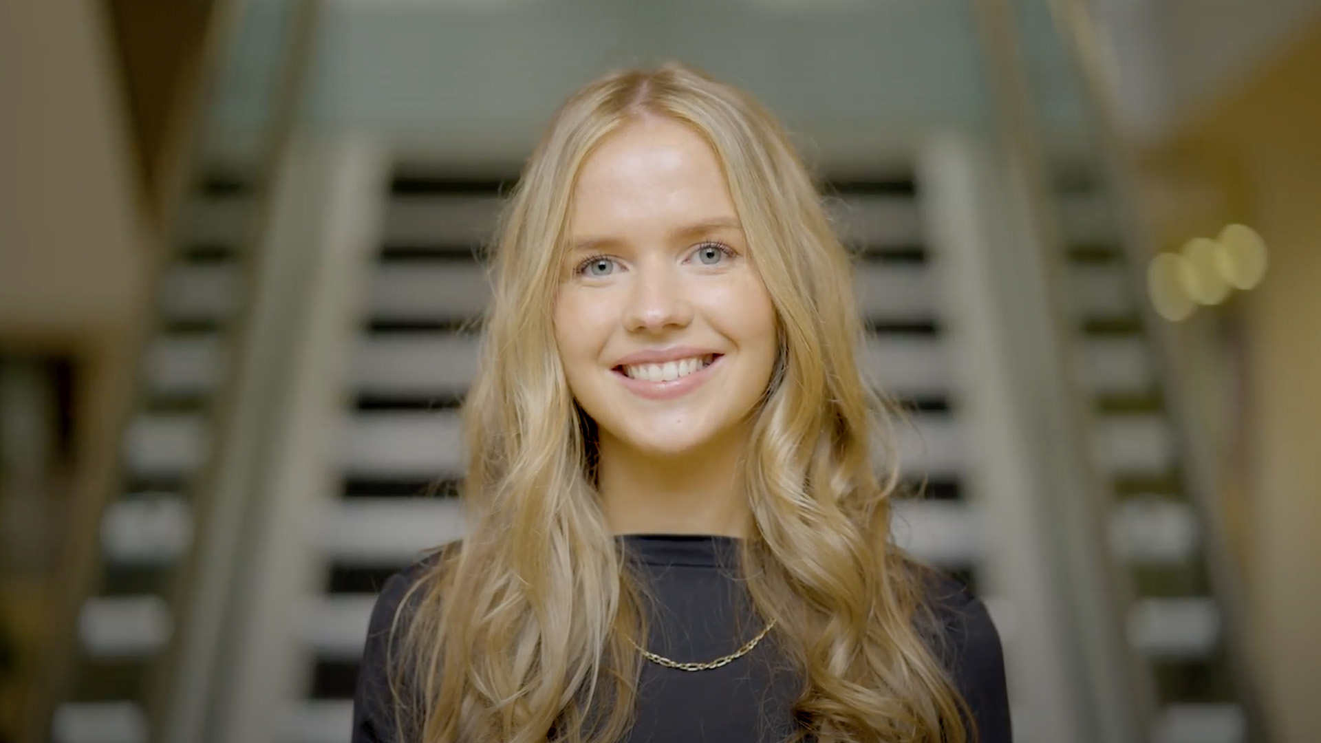 Woman smiling at desk in modern workplace